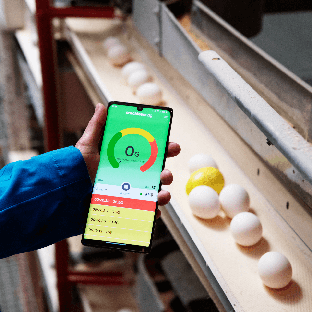 CracklessEgg mobile app displaying 0G force in front of egg handling machine